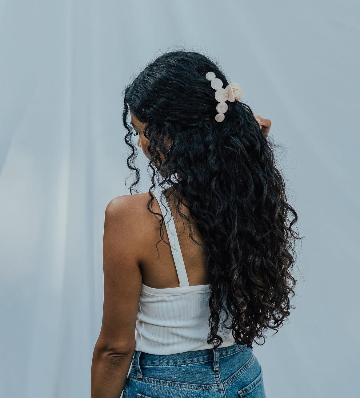 Half-Up Curly Hairstyle With Pearl Claw Clip