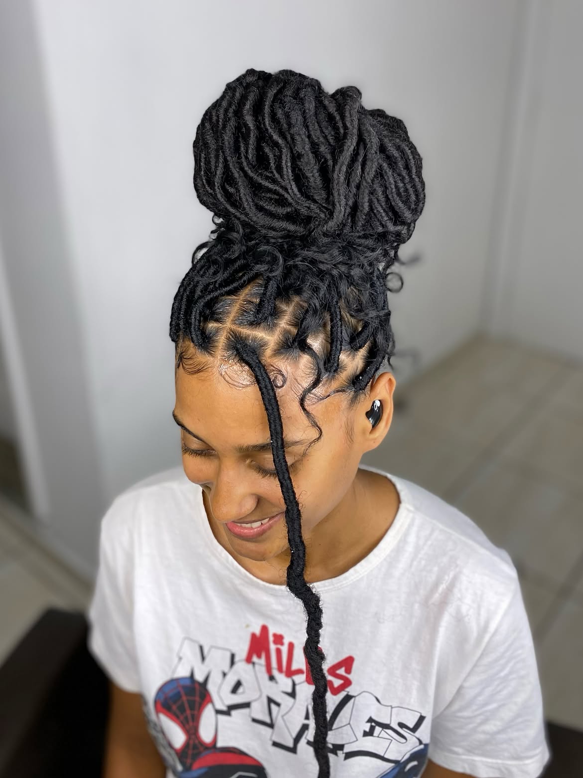 High Top Knot With Wispy Faux Locs Accent