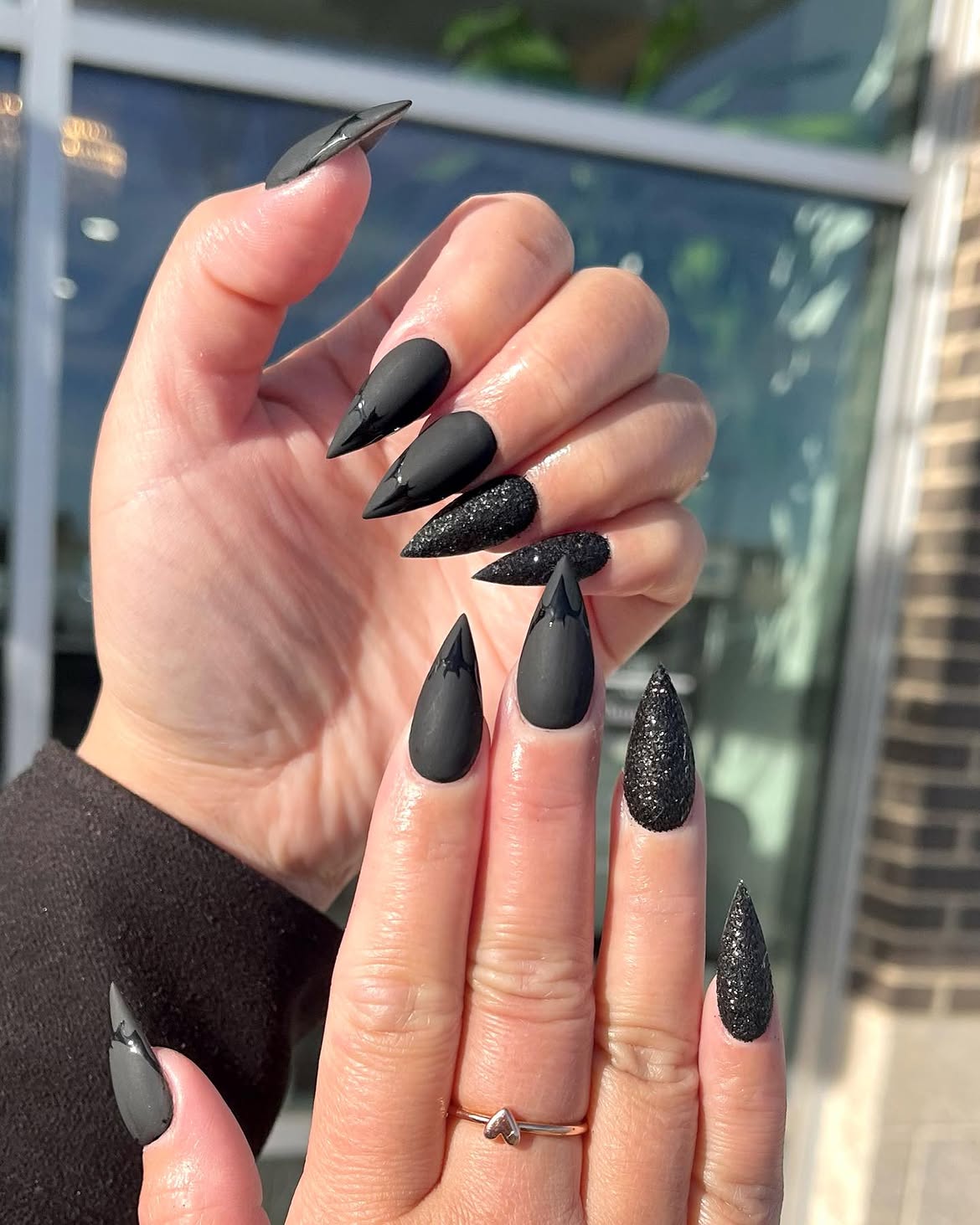 Matte Black Stiletto Nails with Glitter Accents
