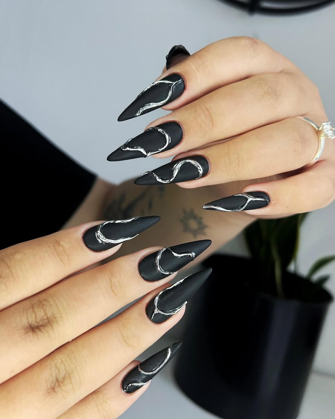 Matte Black Stiletto Nails with Silver Swirl Art