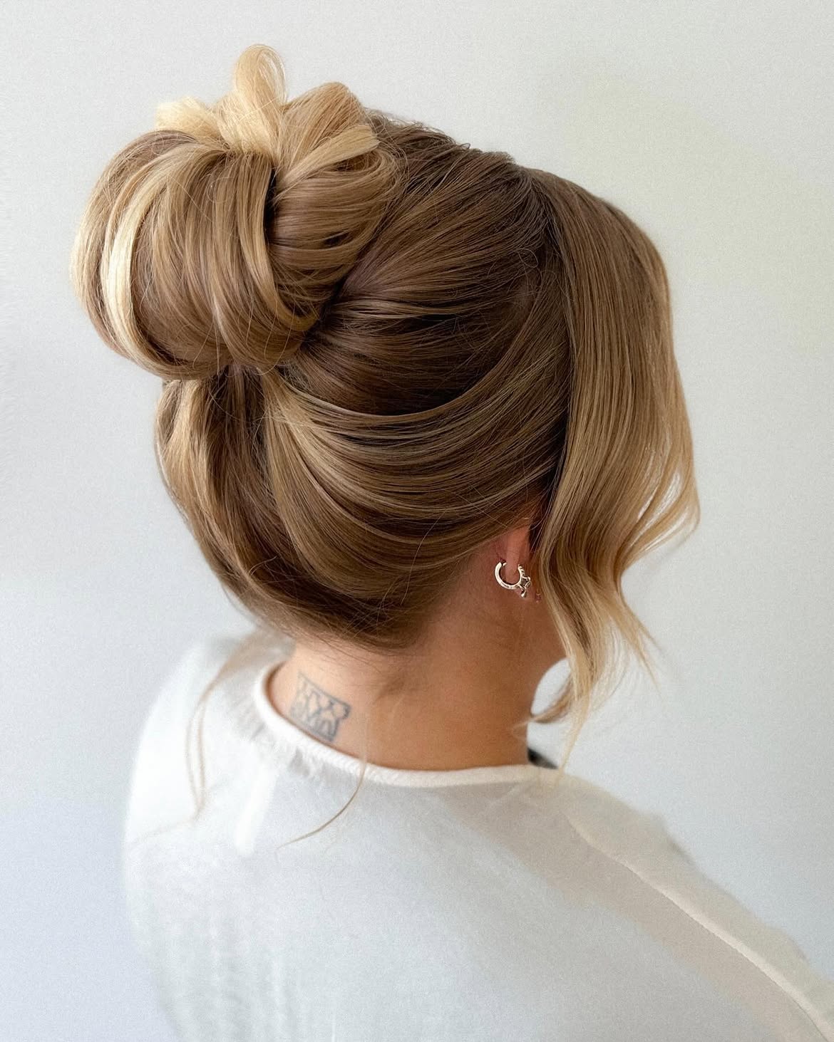 Polished High Bun With Face Framing Strands