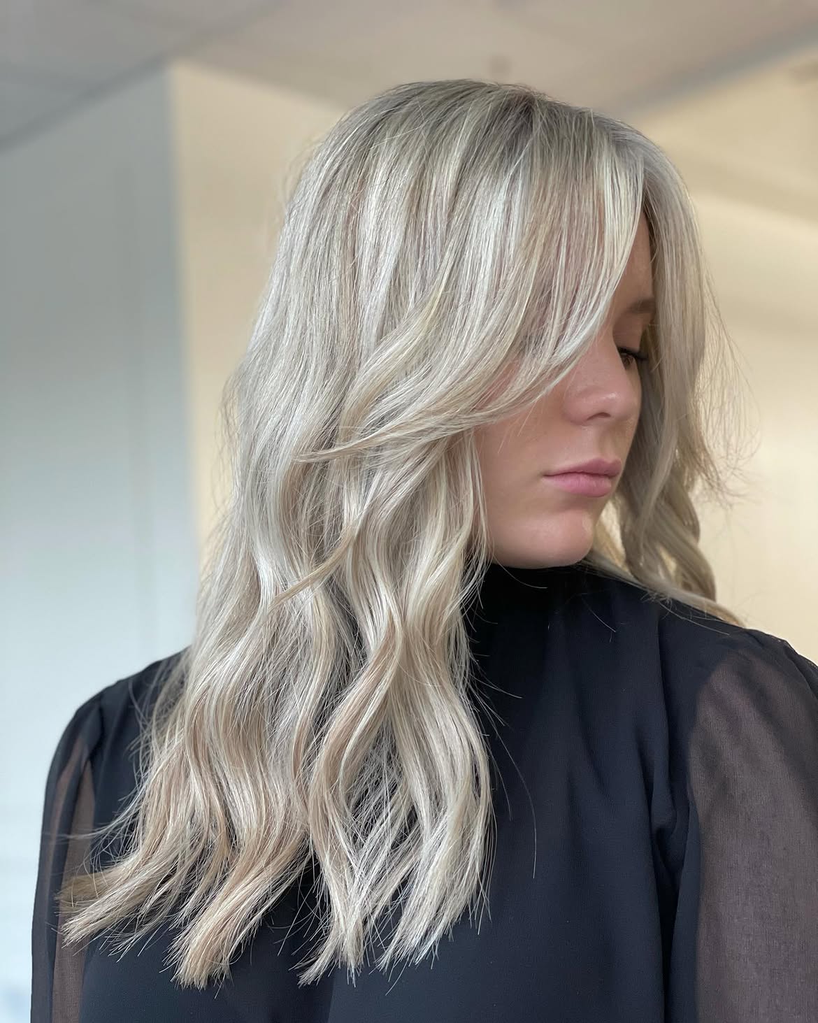 Side Swept Face Framing Layers On Cool Blonde