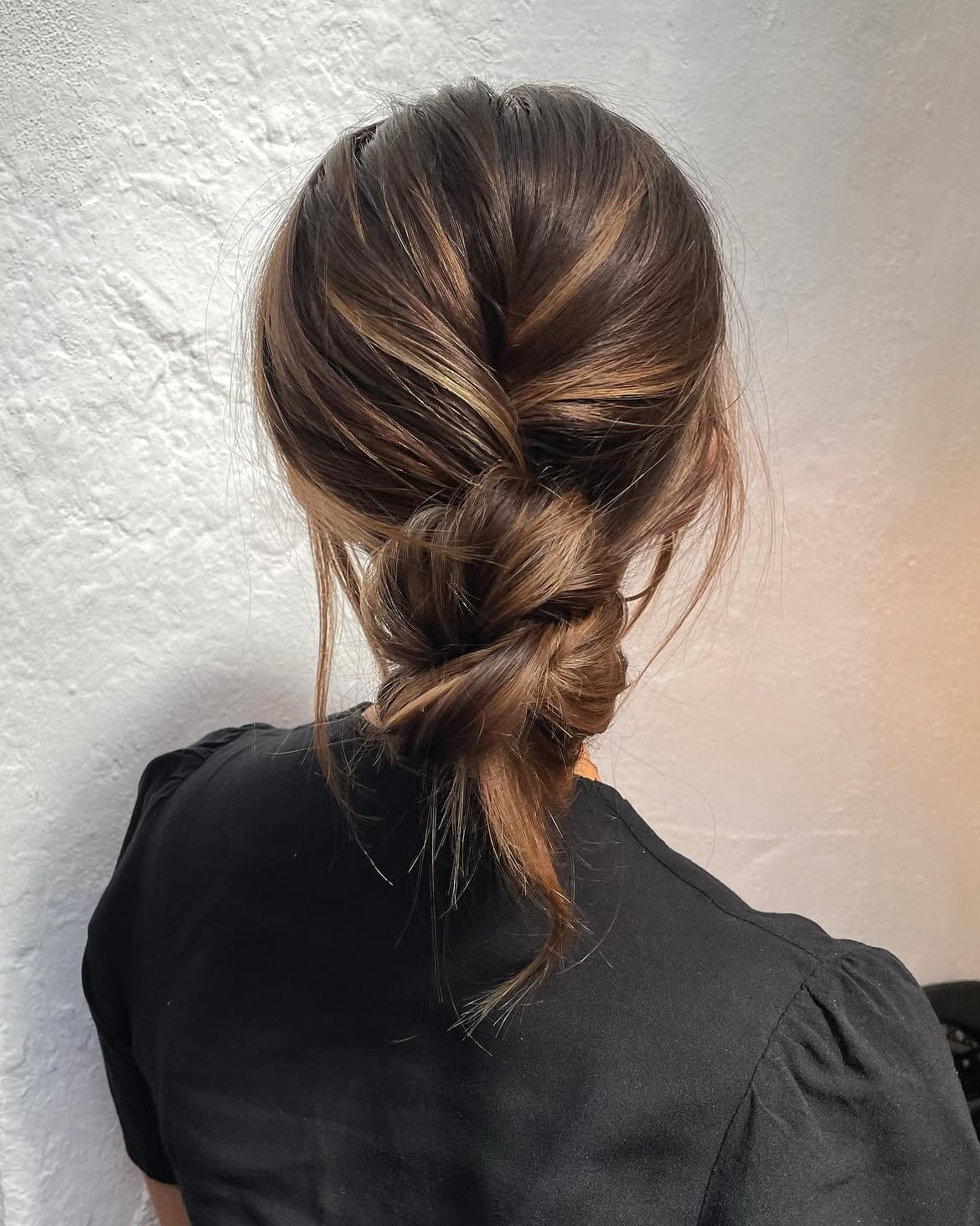 Textured Low Braided Bun With Caramel Highlights