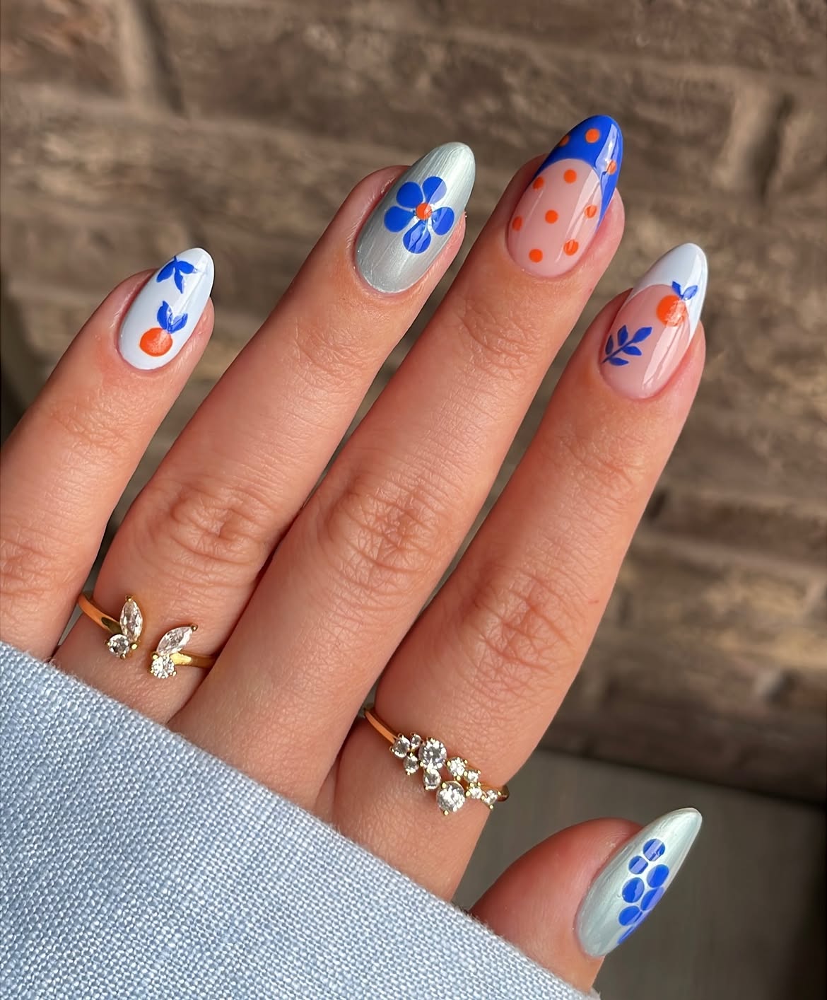Vibrant Blue And Orange Floral Almond Nails