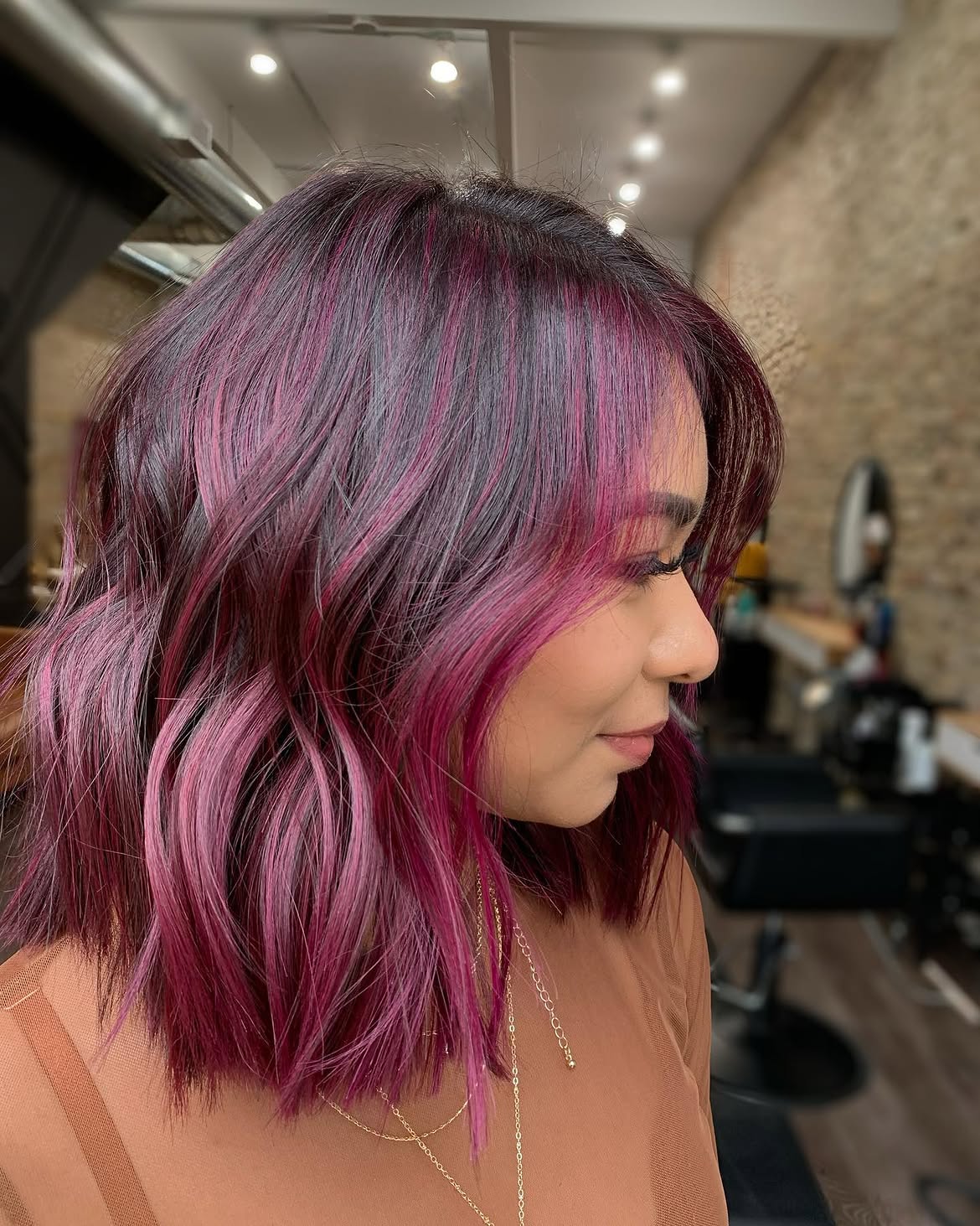 Vibrant Plum Highlights On Textured Shoulder Length Lob