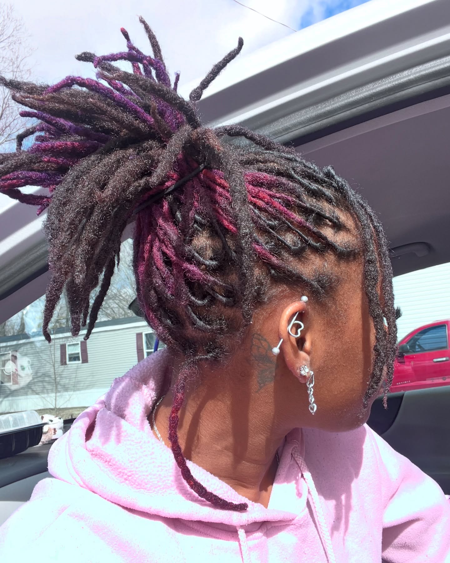Vibrant Purple Streaked High Ponytail Locs