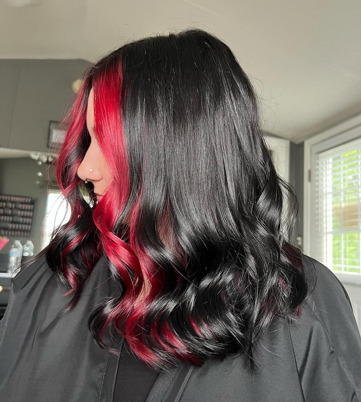Vibrant Red Peekaboo Highlights On Jet Black Waves