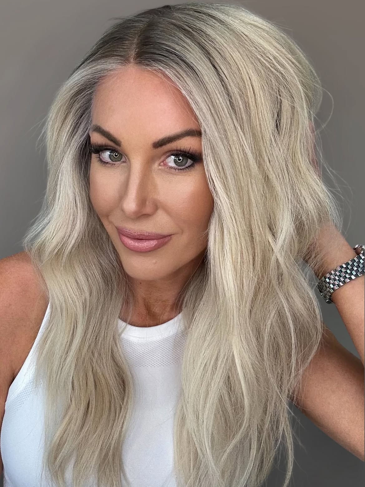 Voluminous Ash Blonde Waves With Dark Roots