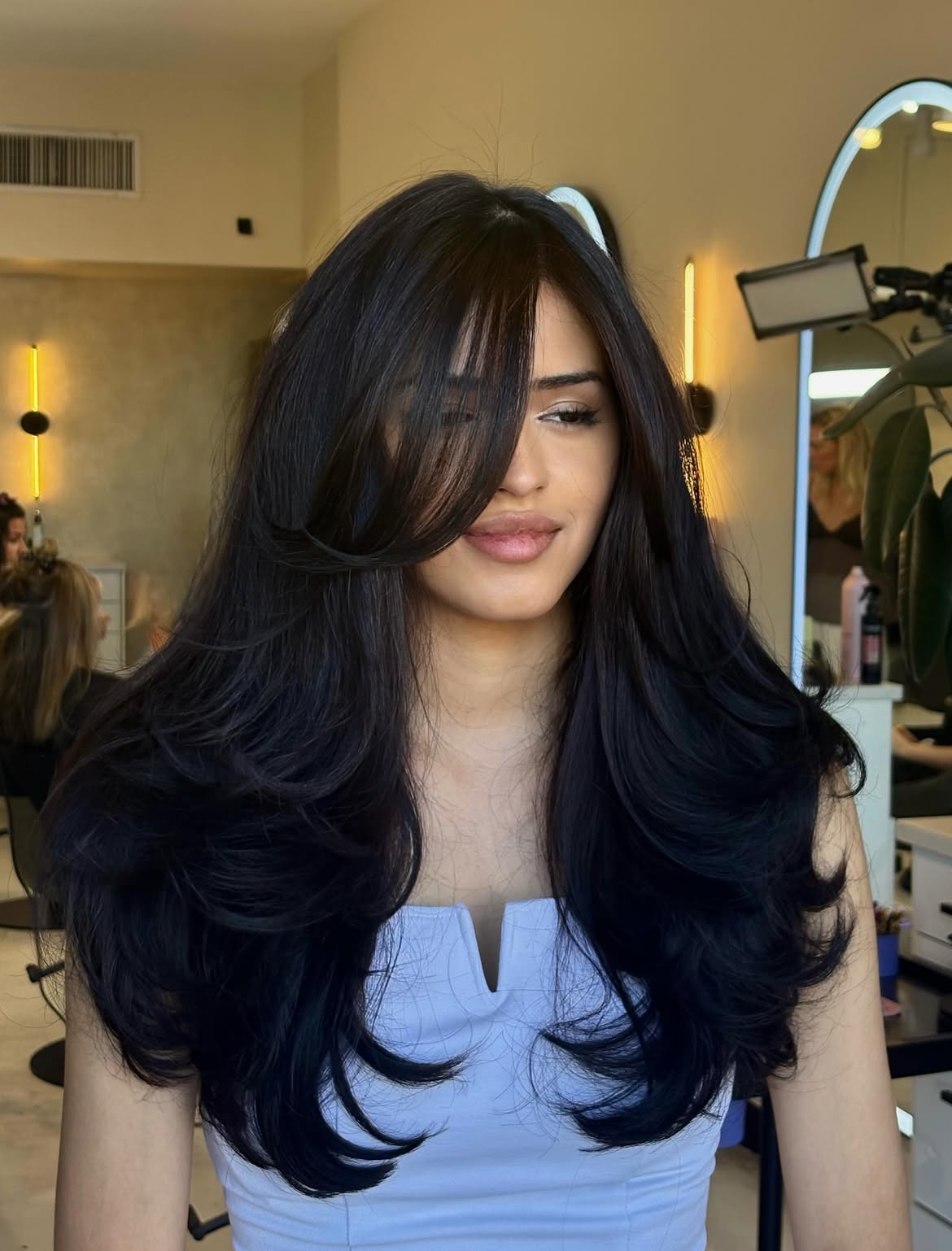 Voluminous Blowout With Face Framing Side Swept Bangs