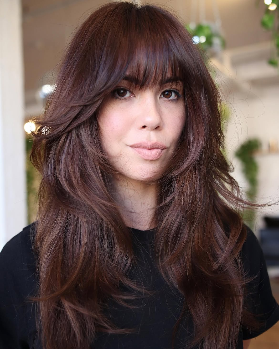 Voluminous Brunette Layers With Wispy Bangs