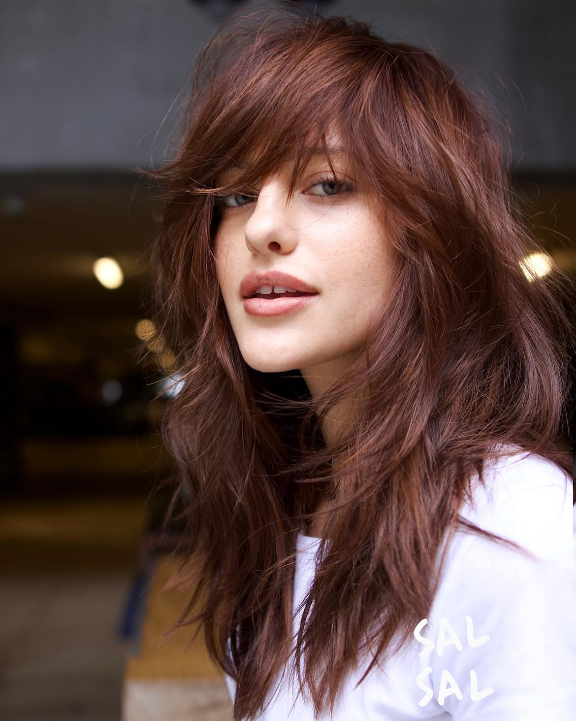 Voluminous Copper Layers With Deep Side Swept Bangs