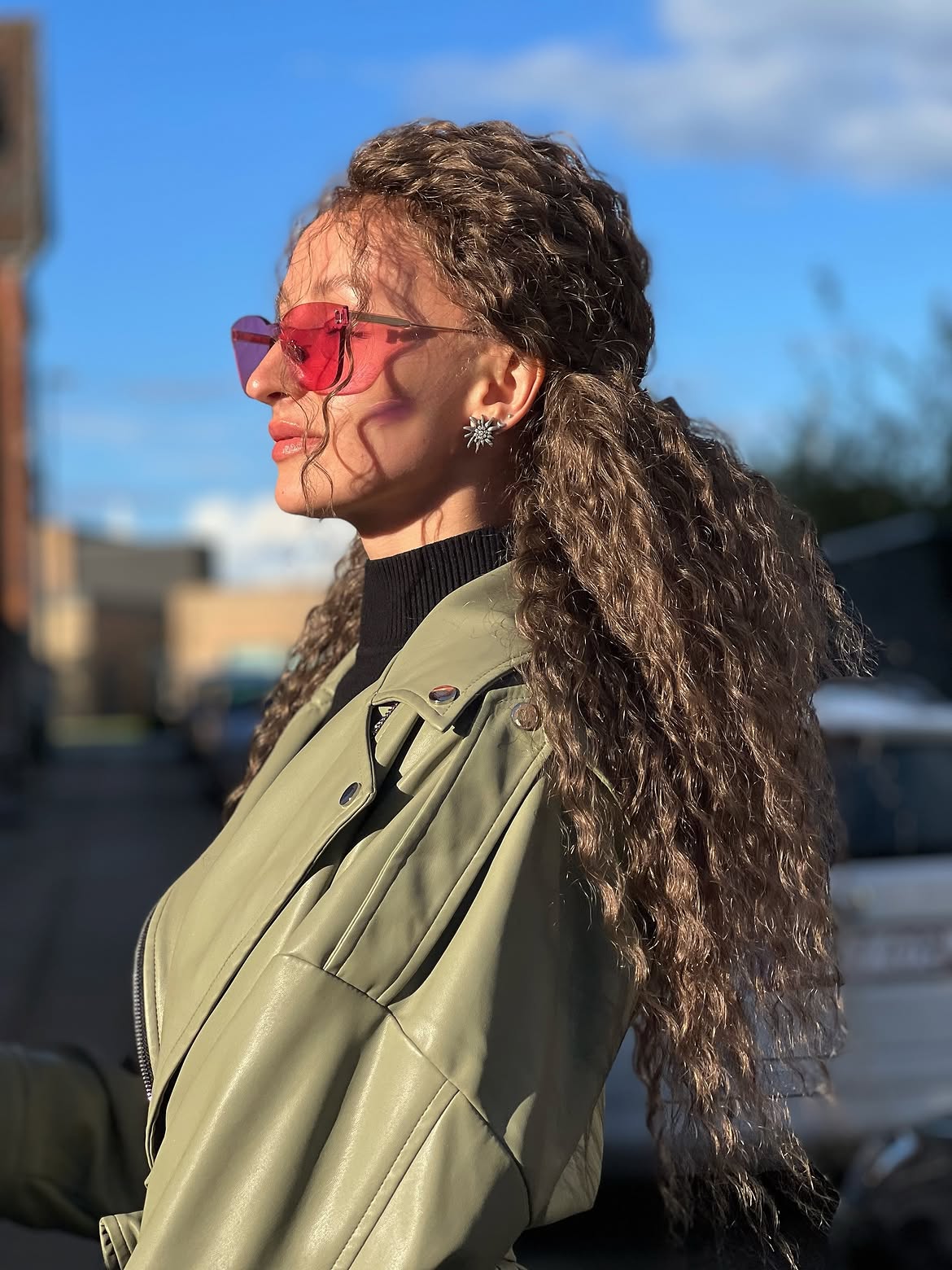 Voluminous Curly Half Up Style With Face Framing Tendrils