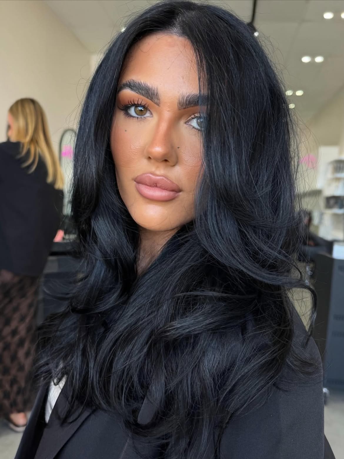 Voluminous Jet Black Layers With Face Framing Waves