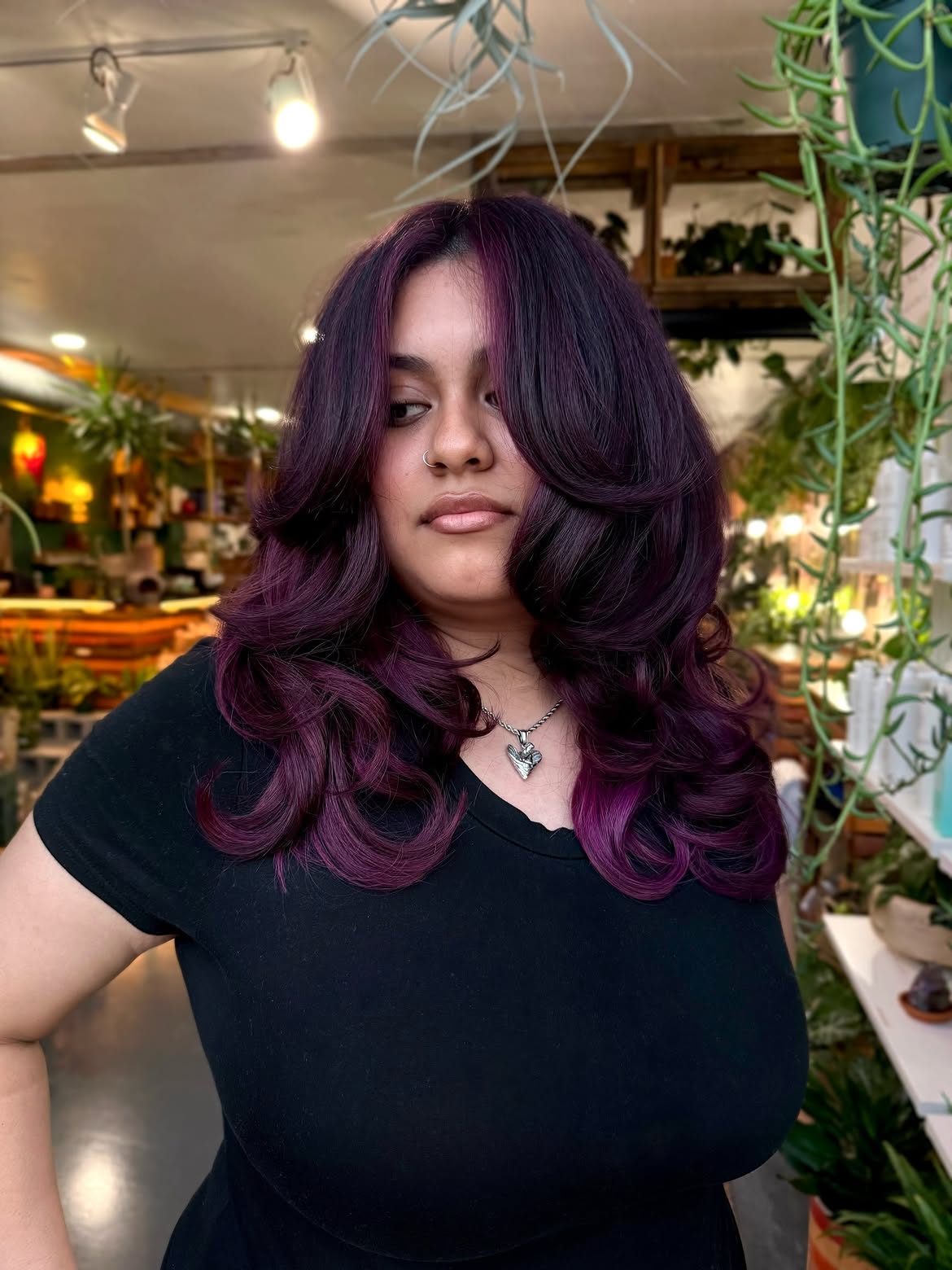 Voluminous Plum Layers With Face Framing Curtain Bangs