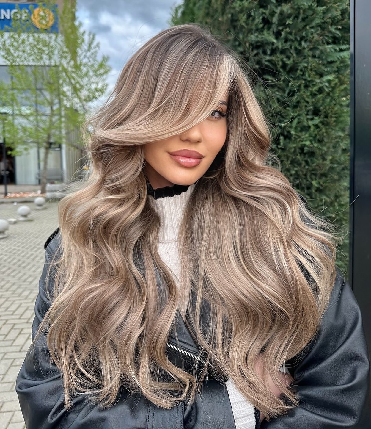 Voluminous Side Swept Bangs On Ashy Bronde Layers