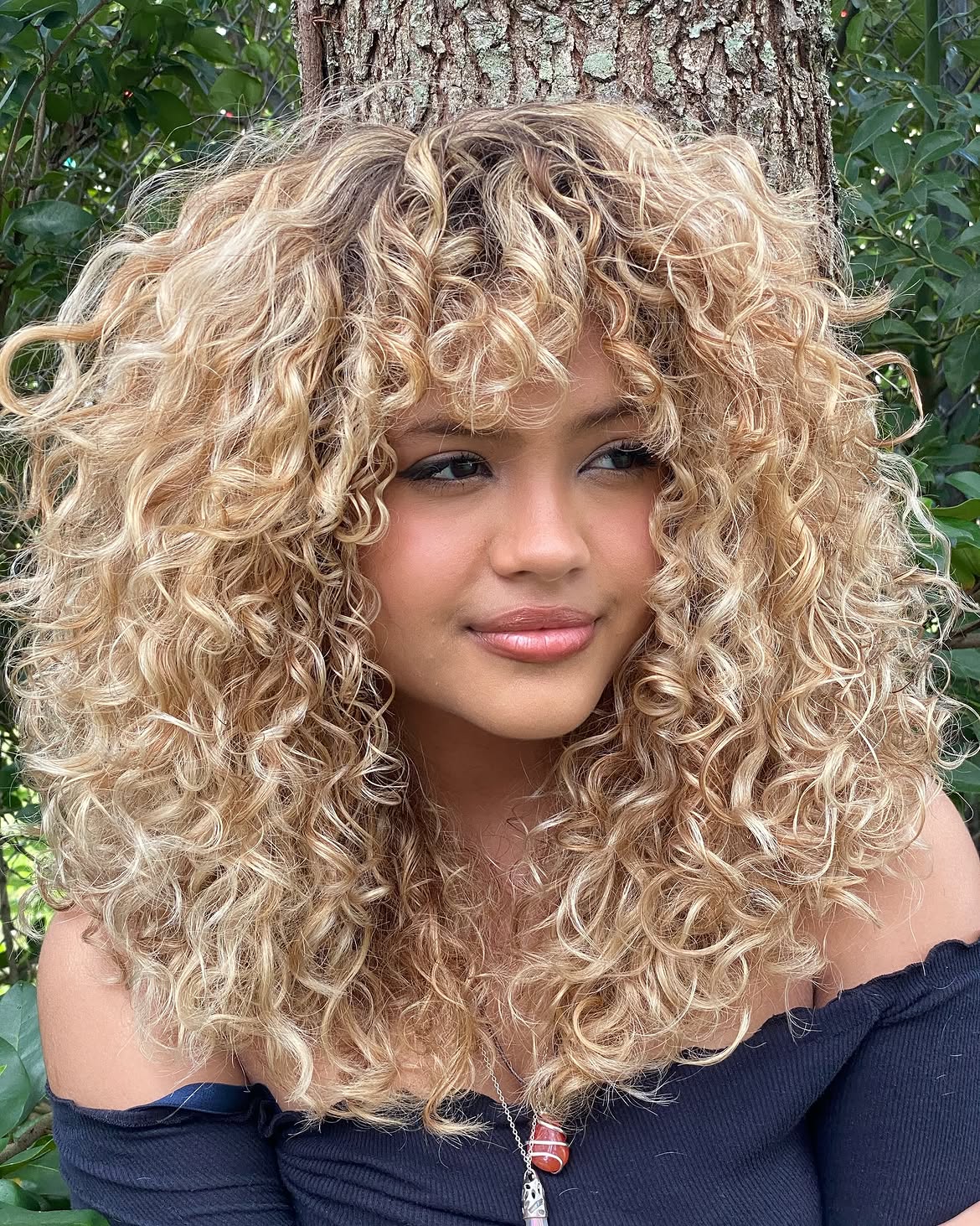 Bronde Curly Hair With Face-Framing Bangs
