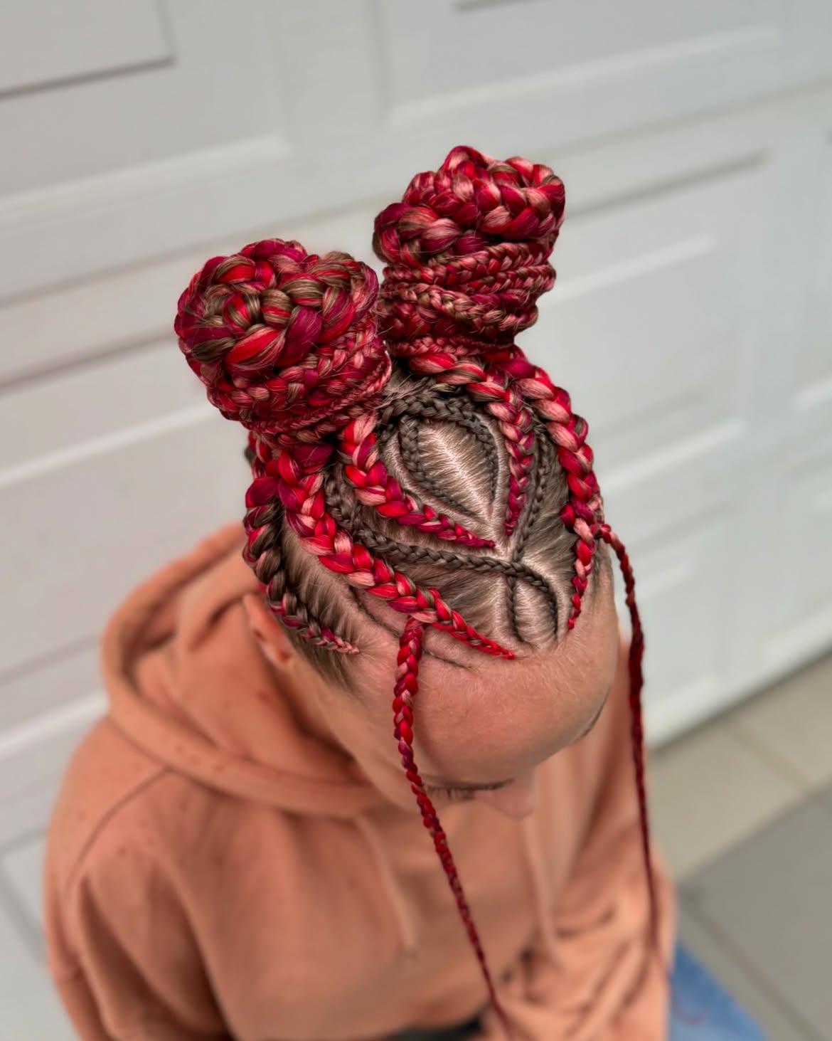 Crimson Braided Space Buns With Intricate Parting