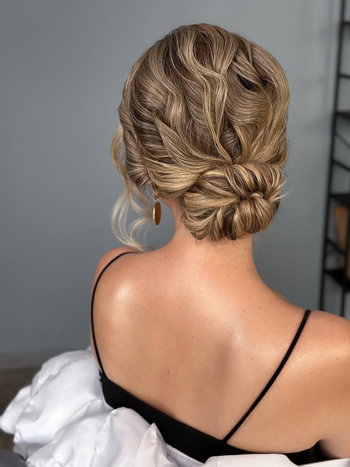 Elegant Braided Low Bun With Wispy Strands