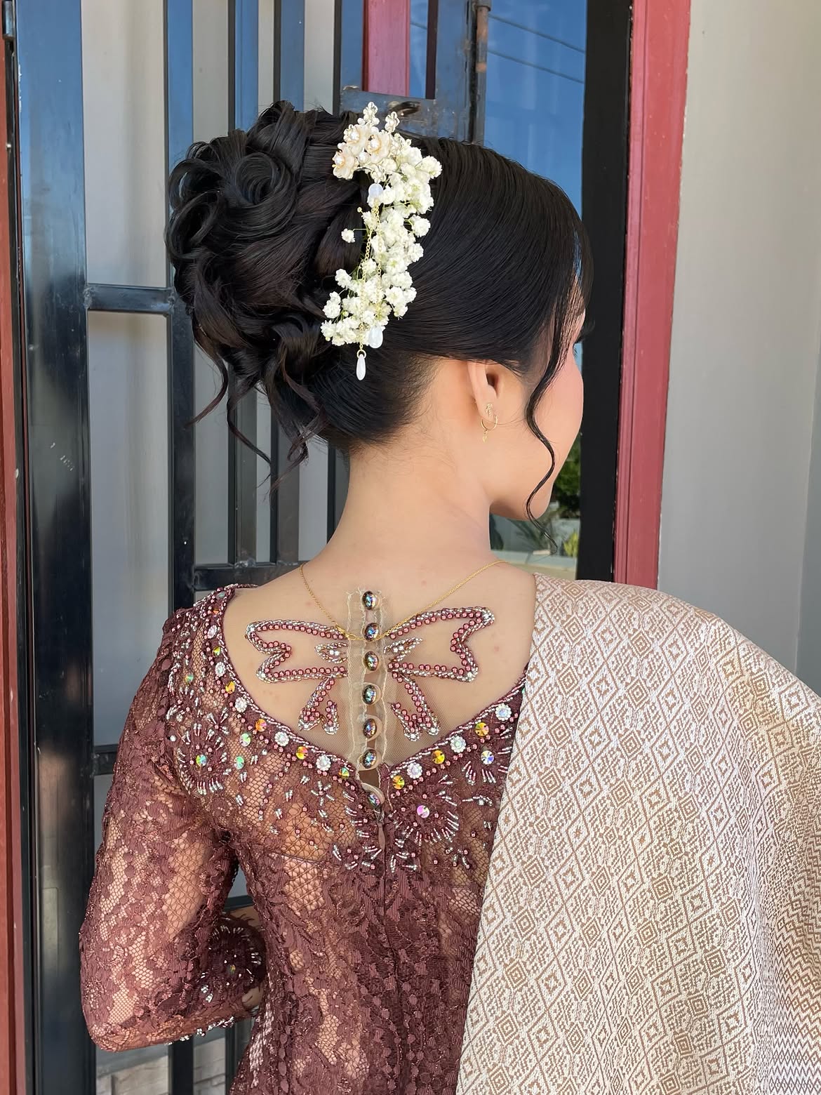 Elegant Floral Updo With Romantic Face Framing Pieces
