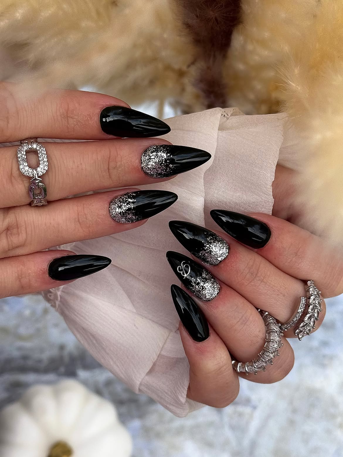 Glossy Black Stiletto Nails with Silver Glitter Accents