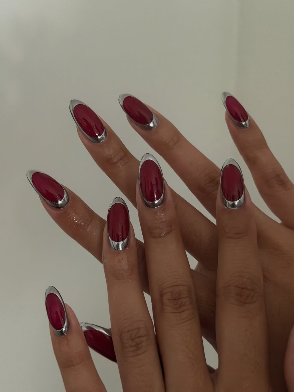 Glossy Burgundy And Silver Chrome French Almond Nails