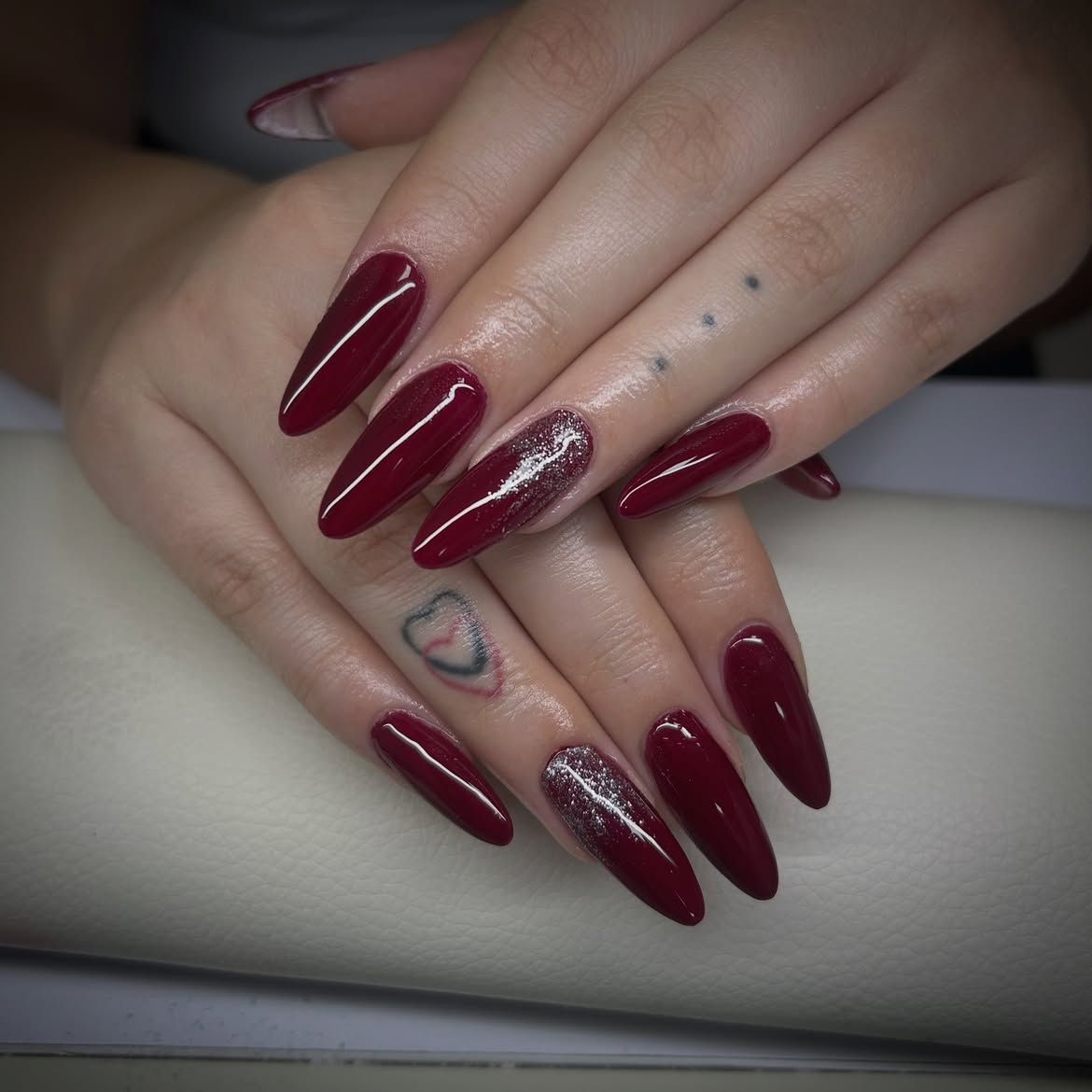 Glossy Burgundy And Silver Glitter Accent Almond Nails