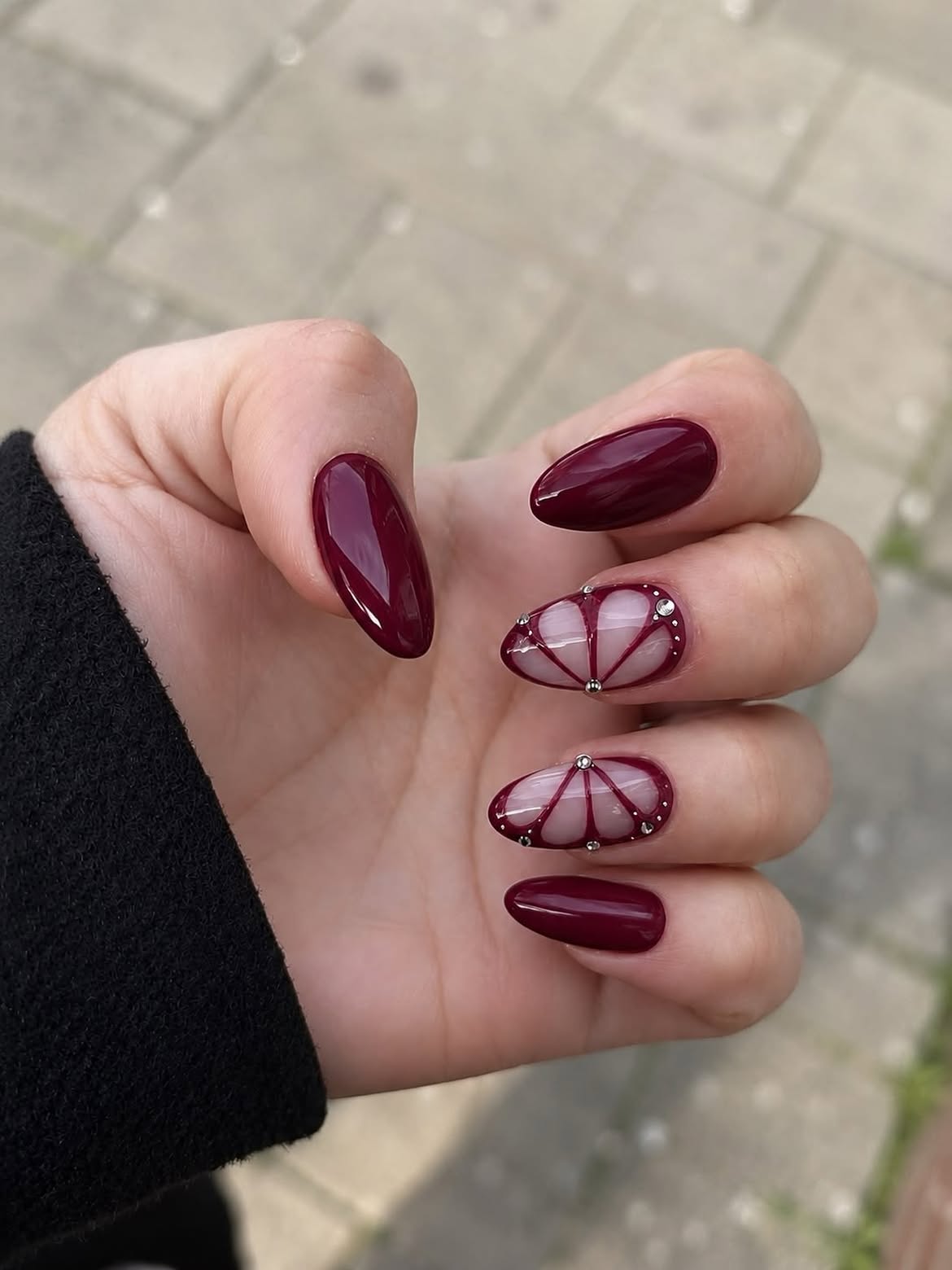 Glossy Burgundy And Silver Spider Gel Almond Nails