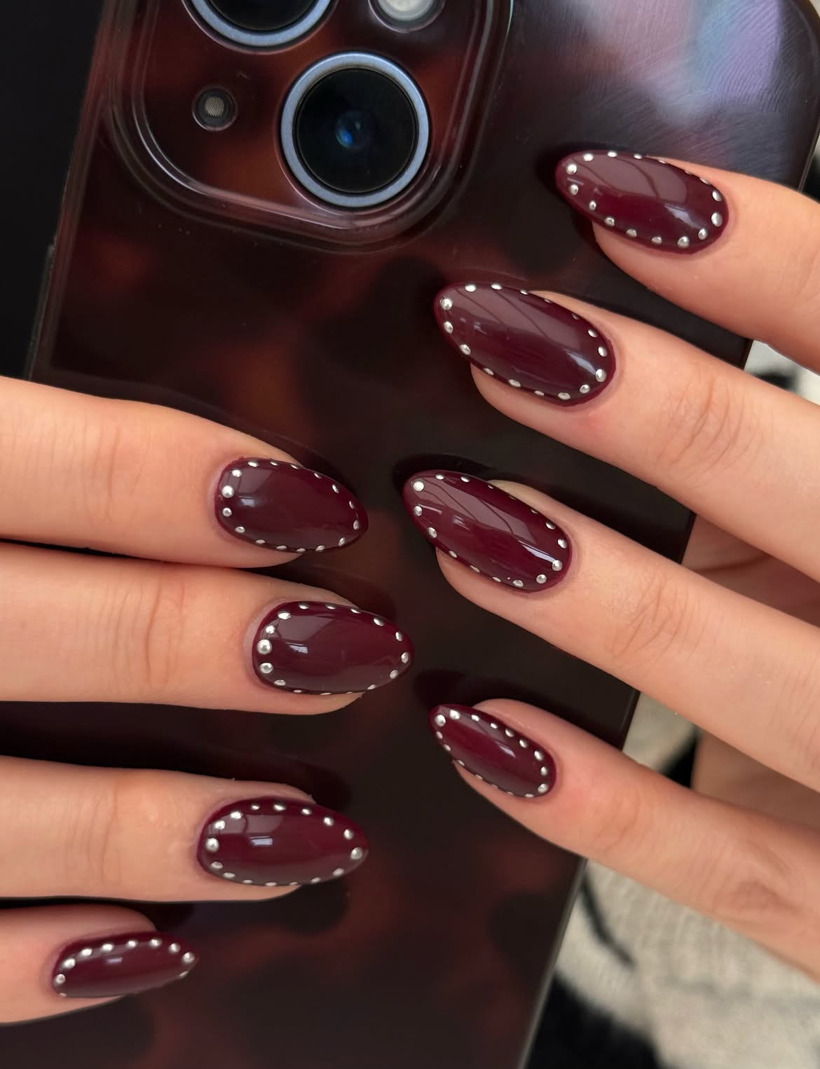 Glossy Burgundy Studded Almond Nails