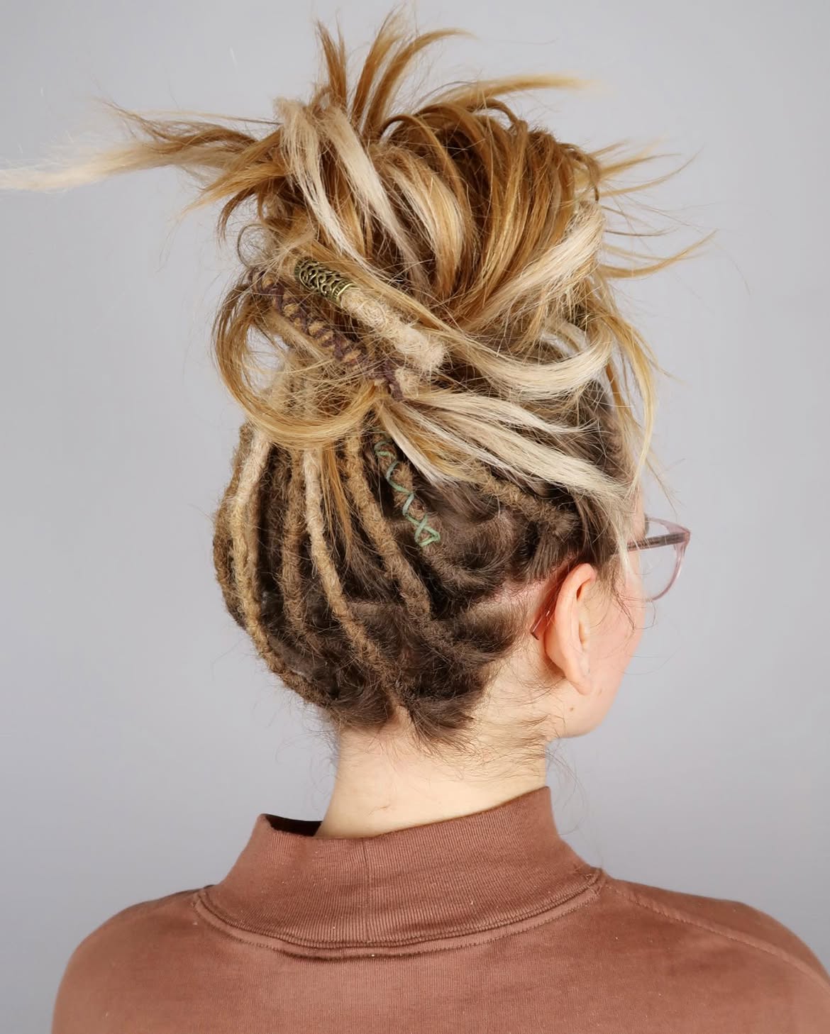 Messy Updo With Wrapped Dreadlocks and Blonde Strands