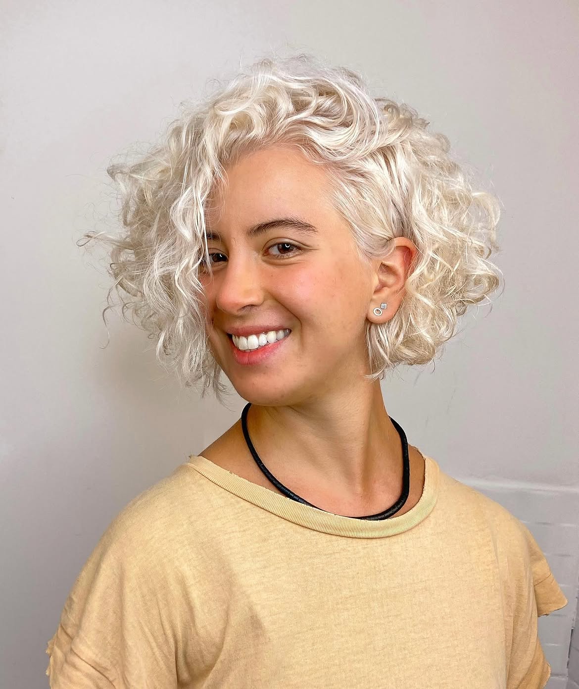 Platinum Blonde Textured Bob With Defined Curls