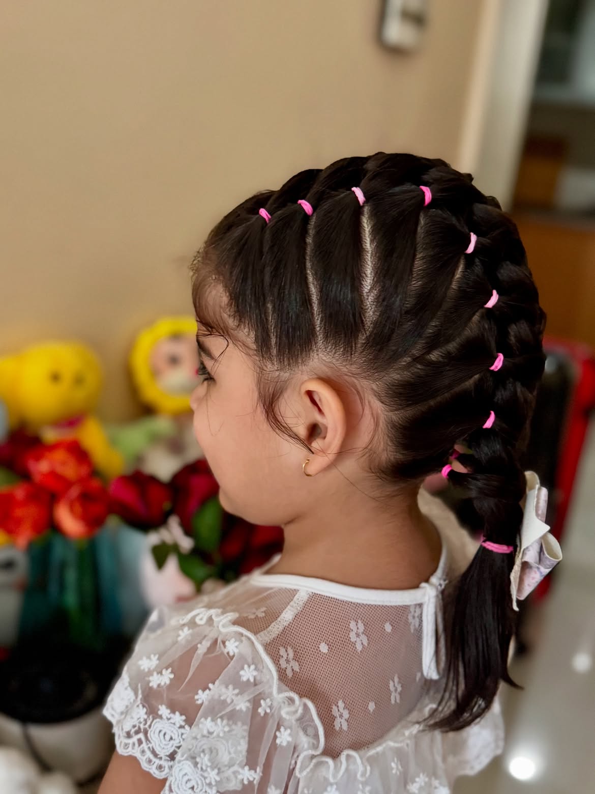 Playful Segmented Ponytail Braid With Pink Elastics