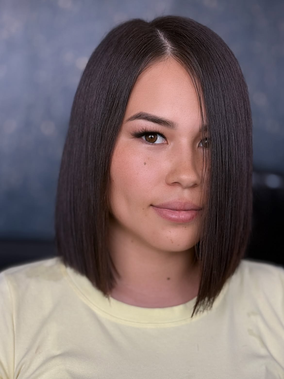 Sleek Chocolate Brown Collarbone Bob With A Deep Side Part
