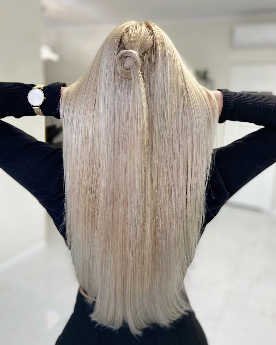 Sleek Platinum Blonde Hair With A Chic Top Knot