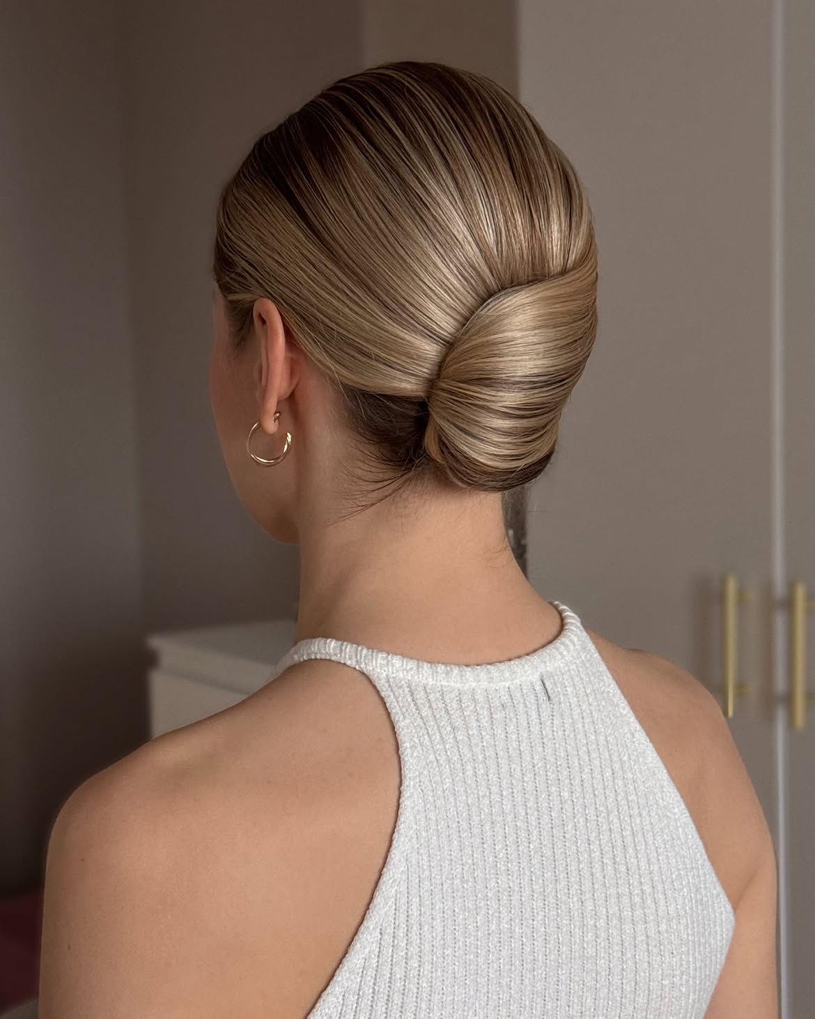 Sleek Twisted Chignon With Honey Blonde Highlights