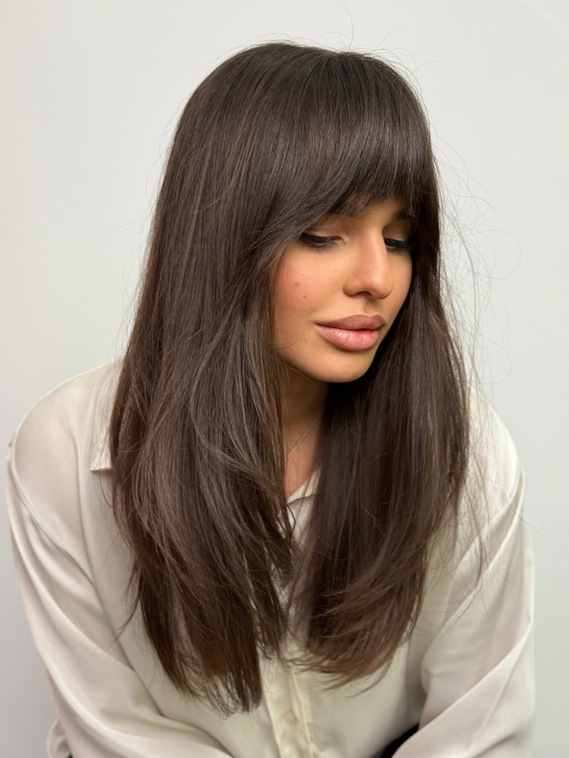 Soft Face-Framing Layers With Wispy Bangs