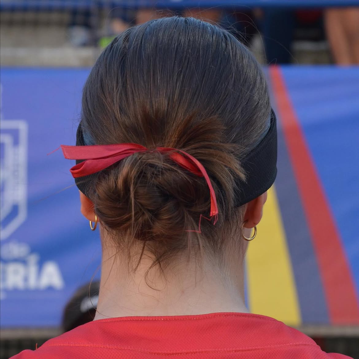 Sporty Low Bun With Red Ribbon Accent