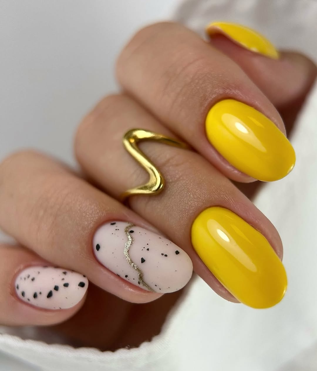 Sunny Yellow Oval Nails with Speckled Accents