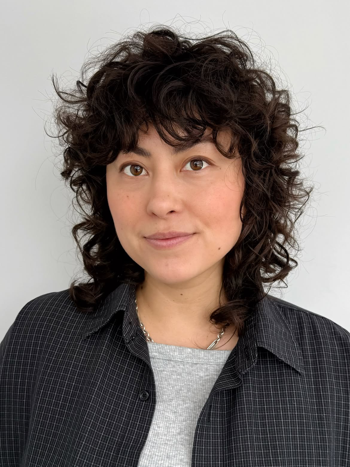Textured Dark Curly Shag With Wispy Bangs