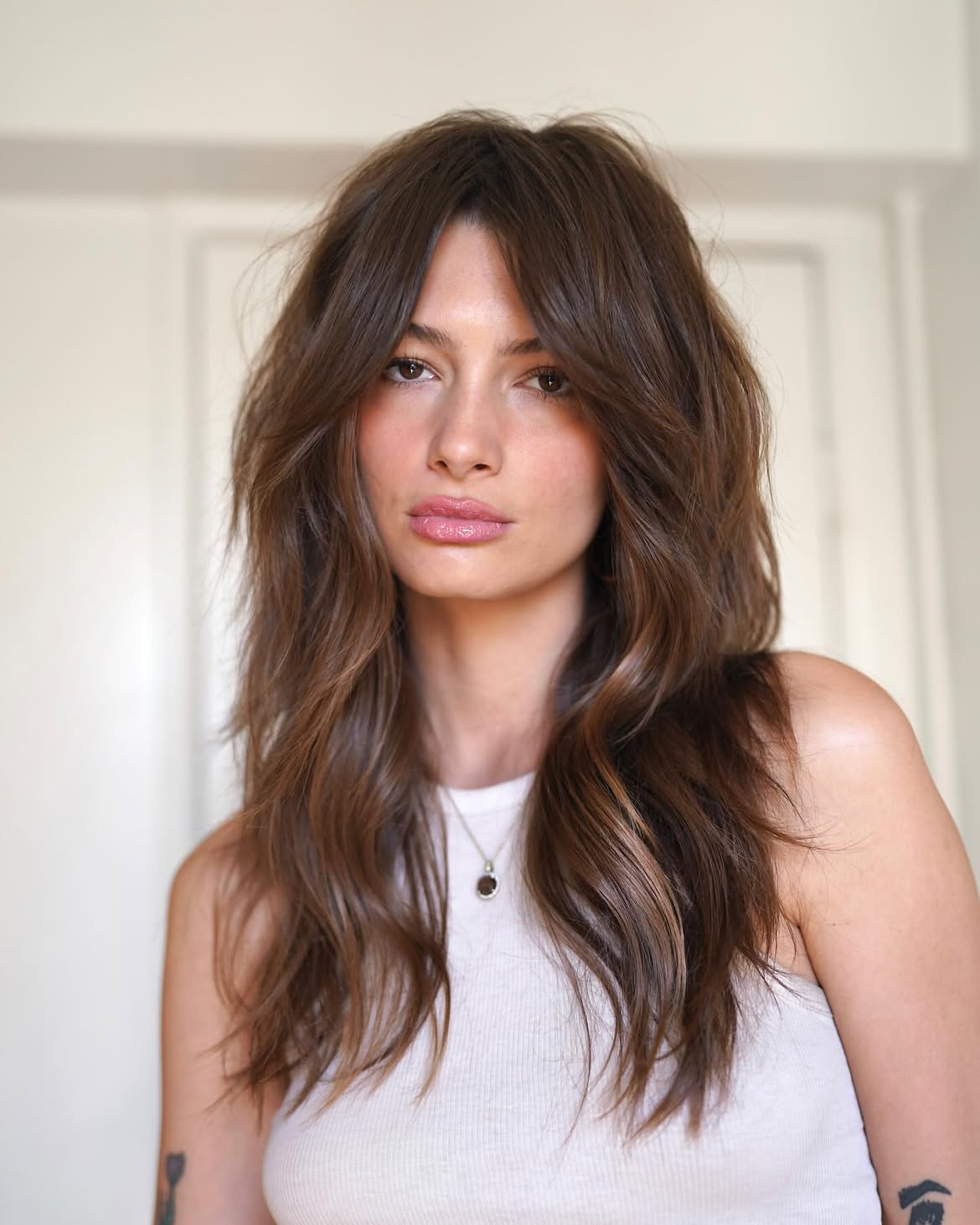 Tousled Curtain Bangs With Warm Brunette Waves