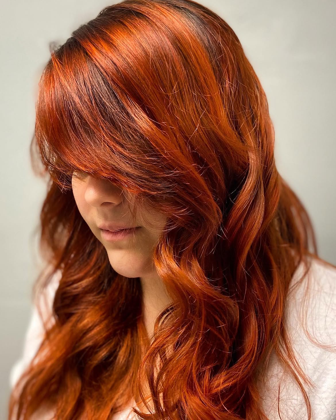Vibrant Copper Layered Hair With Side Bangs