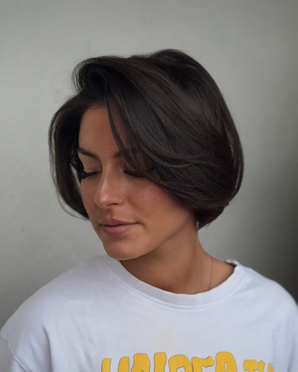 Voluminous Brunette French Bob With Side Swept Layers