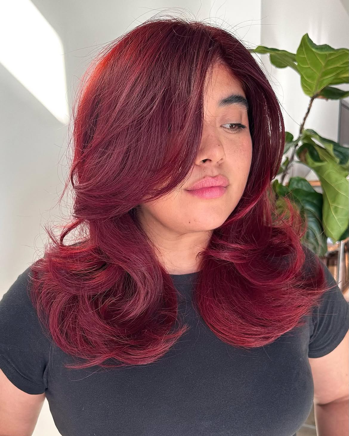 Voluminous Deep Red Layers With Soft Curtain Bangs