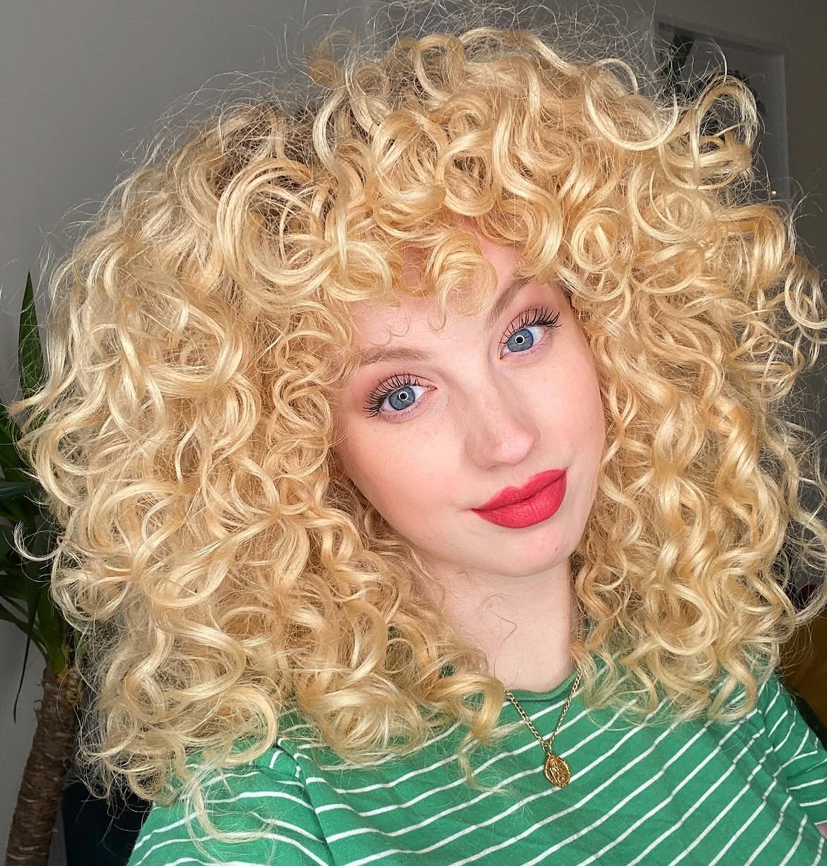 Voluminous Honey Blonde Spiral Curls With Bangs