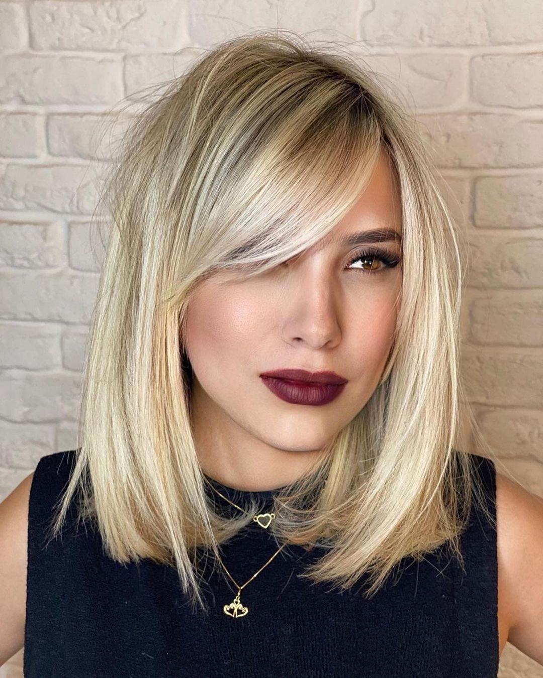 Voluminous Side Swept Bangs On Blonde Lob