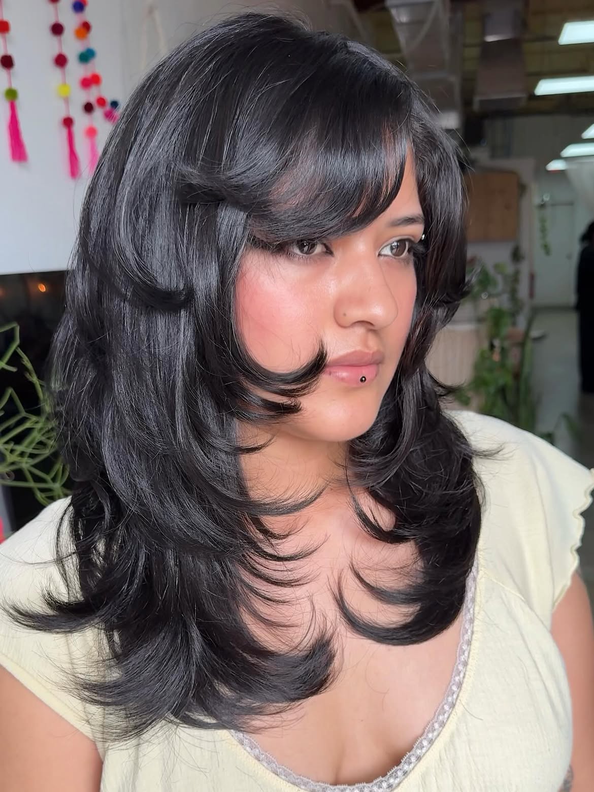 Voluminous Side Swept Layers On Jet Black Hair