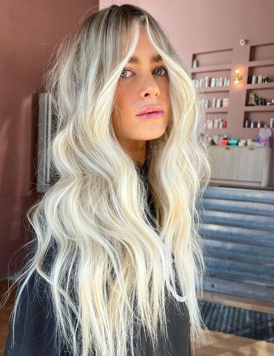 Mid-Back Cool Ash Blonde Balayage With Curtain Bangs and Loose Waves — Balayage Hair Blonde