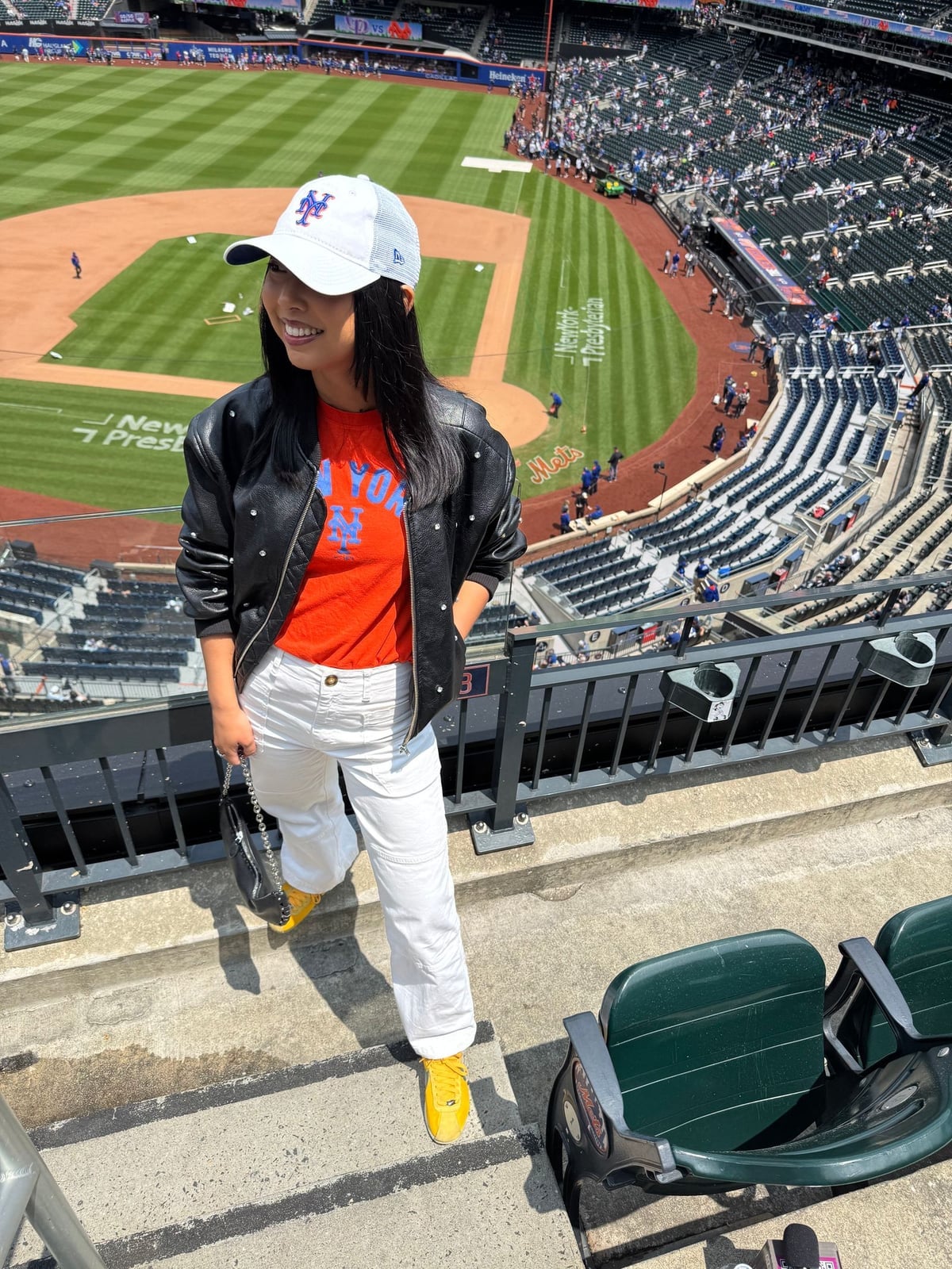 Graphic T-shirt With Studded Bomber Jacket And White Pants — Baseball Game Outfits