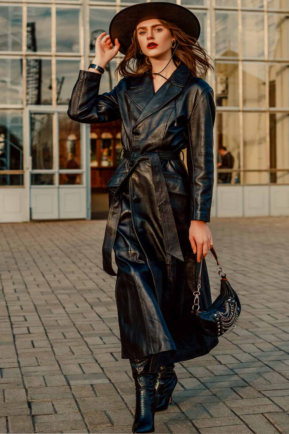 A Dramatic Black Leather Trench Coat with Snakeskin Boots — Black Trench Coat Outfit