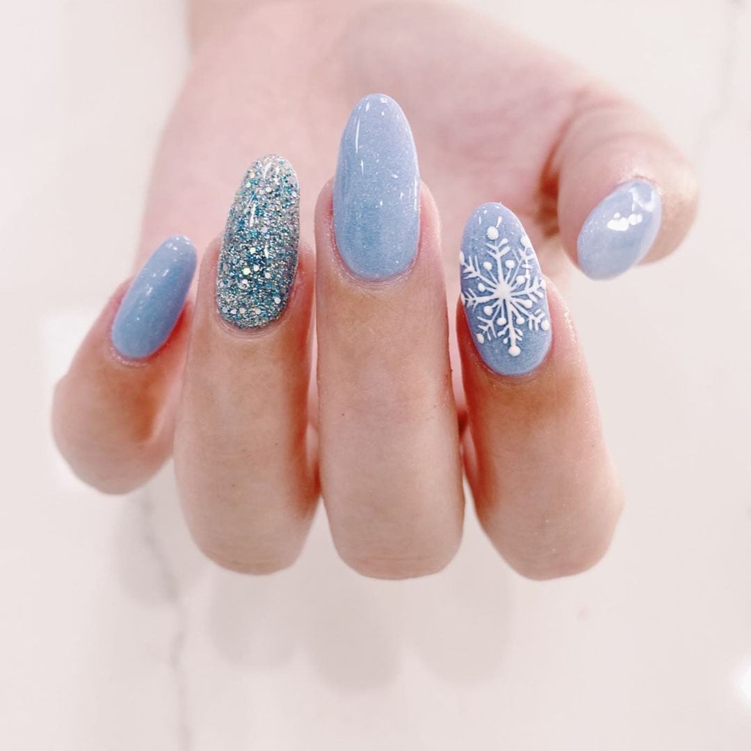 Medium Almond Milky Blue Snowflake Glitter Nails Medium Almond Milky Blue Snowflake Glitter Nails — Blue Christmas Nails