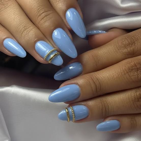 Light Sky Blue Glossy Almond Nails with Gold Band, Close-Up Take Light Sky Blue Glossy Almond Nails with Gold Band, Close-Up Take — Blue Nails